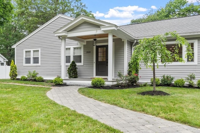 2028 Main St, Concord, MA 01742 - view of front of home with a front lawn, a porch, and roof with shingles