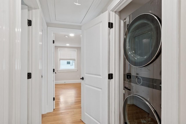 2028 Main St, Concord, MA 01742 - laundry room featuring stacked washer and clothes dryer and light wood-type flooring