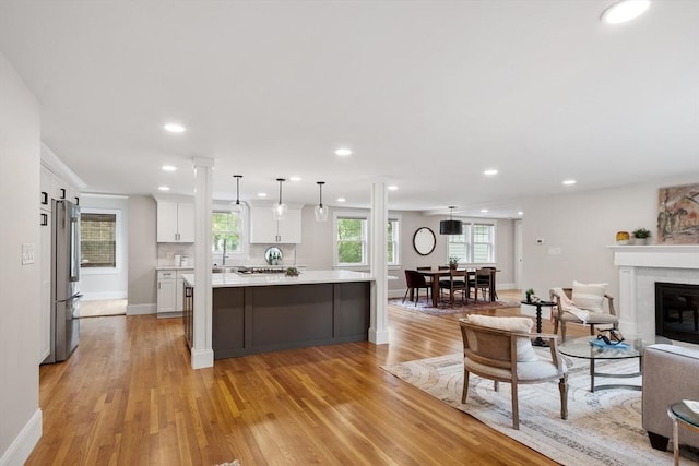 2028 Main St, Concord, MA 01742 - kitchen with freestanding refrigerator, open floor plan, light countertops, white cabinets, and light wood-type flooring