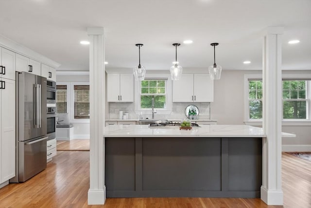 2028 Main St, Concord, MA 01742 - kitchen with appliances with stainless steel finishes, white cabinets, light wood-style floors, and recessed lighting