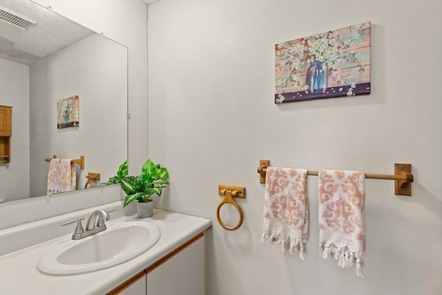 bathroom featuring visible vents and vanity