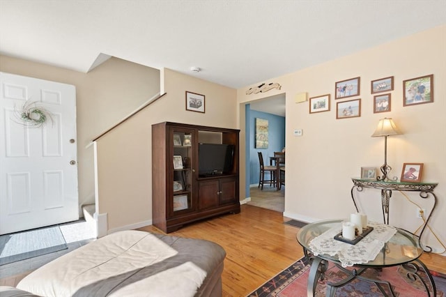 bedroom featuring baseboards and light wood-type flooring