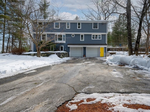 view of front facade with aphalt driveway and a garage