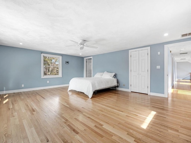 unfurnished bedroom with recessed lighting, visible vents, light wood-style floors, a ceiling fan, and baseboards