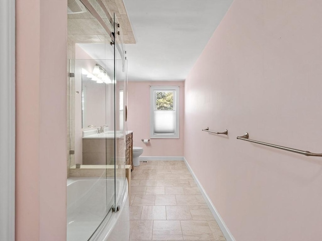 bathroom featuring baseboards, toilet, a bathing tub, a shower with shower door, and vanity