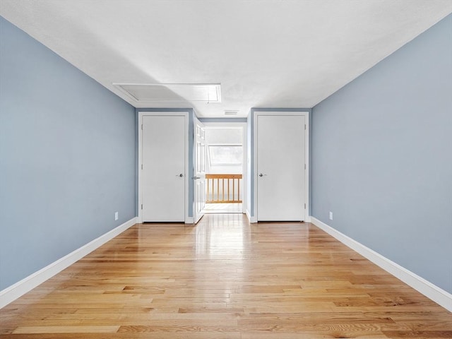 interior space featuring baseboards, visible vents, and light wood-style floors