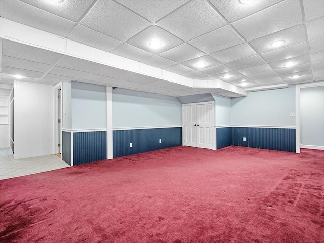 finished below grade area featuring recessed lighting, carpet, a drop ceiling, and wainscoting