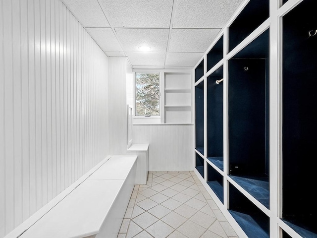 mudroom with a paneled ceiling and tile patterned floors