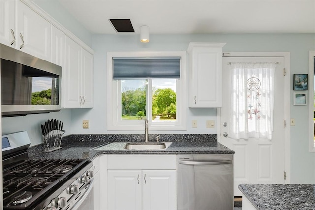 5 Bayview Ave, Fairhaven, MA 02719 - kitchen featuring stainless steel appliances, a sink, white cabinets, and dark stone countertops