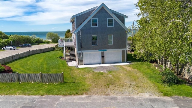 5 Bayview Ave, Fairhaven, MA 02719 - view of home's exterior with stairway, dirt driveway, a garage, and a deck with water view