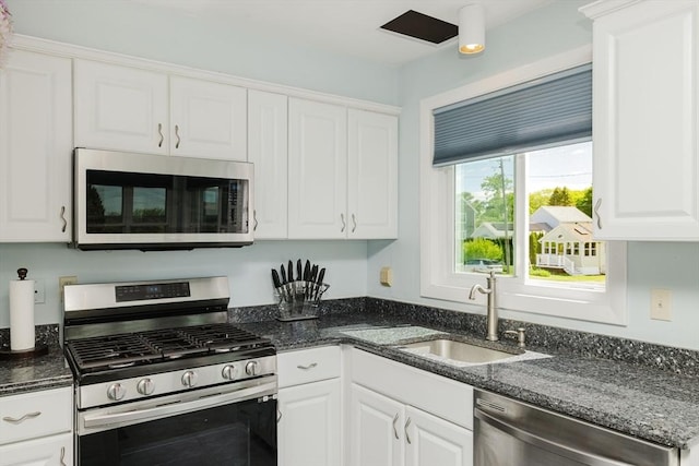 5 Bayview Ave, Fairhaven, MA 02719 - kitchen featuring stainless steel appliances, a sink, white cabinetry, and dark stone countertops
