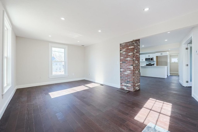 unfurnished living room featuring dark hardwood / wood-style flooring