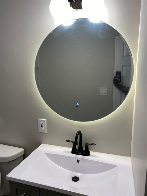 bathroom featuring vanity and toilet