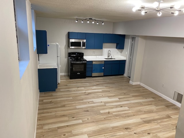 kitchen featuring a chandelier, light hardwood / wood-style floors, rail lighting, stainless steel appliances, and blue cabinetry