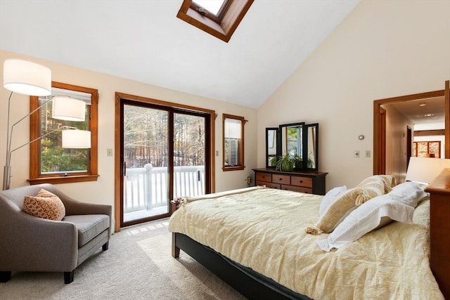 bedroom with light carpet, access to exterior, high vaulted ceiling, and a skylight