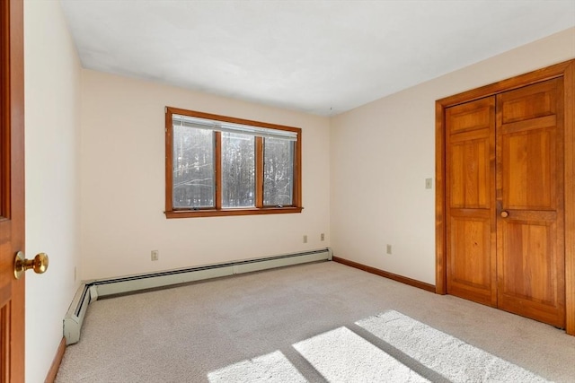 unfurnished bedroom featuring a baseboard radiator and light colored carpet