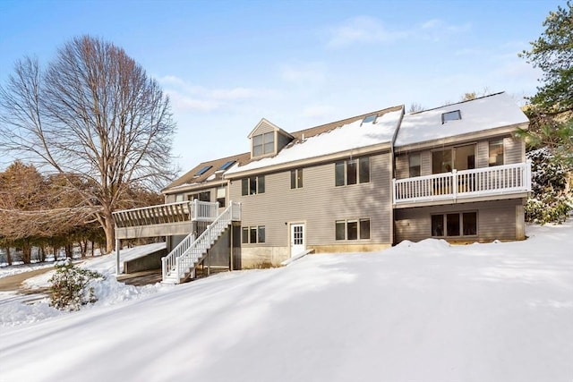 snow covered property featuring a wooden deck