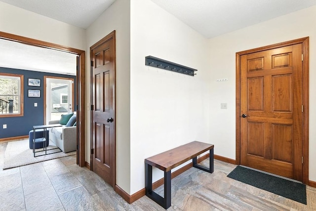 foyer featuring baseboards