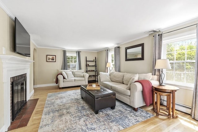 15 Maple St, Salem, MA 01970 - living area featuring a brick fireplace, wood finished floors, and ornamental molding