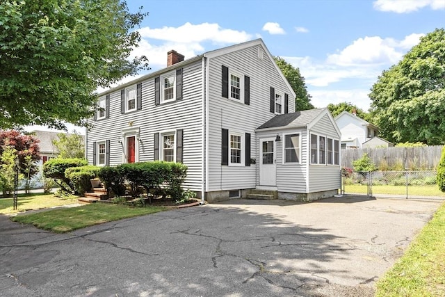 15 Maple St, Salem, MA 01970 - view of front facade featuring entry steps, a chimney, and asphalt driveway