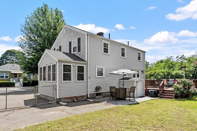 15 Maple St, Salem, MA 01970 - back of property featuring a deck, a chimney, a patio area, and a gate