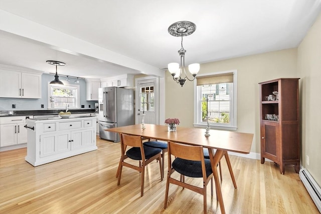 15 Maple St, Salem, MA 01970 - dining area featuring a baseboard radiator, a chandelier, and light wood-type flooring