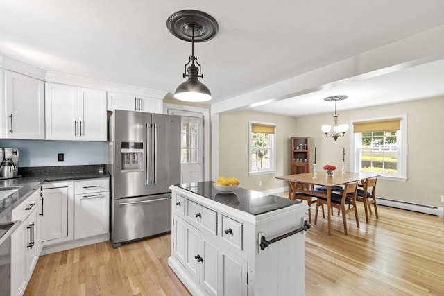 15 Maple St, Salem, MA 01970 - kitchen featuring high end fridge, baseboard heating, dark countertops, a chandelier, and white cabinetry