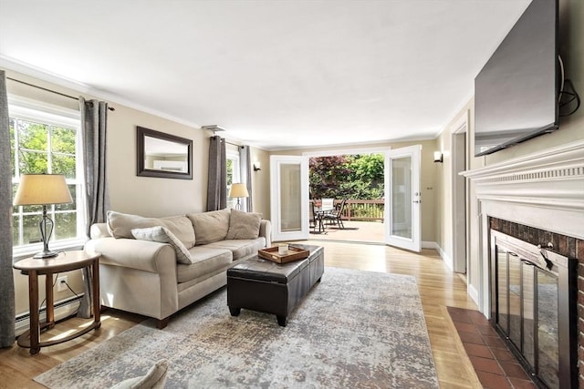 15 Maple St, Salem, MA 01970 - living area with a tile fireplace, baseboard heating, ornamental molding, and wood finished floors