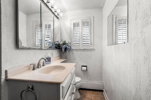 bathroom featuring tile patterned floors, toilet, a baseboard radiator, vanity, and a textured wall