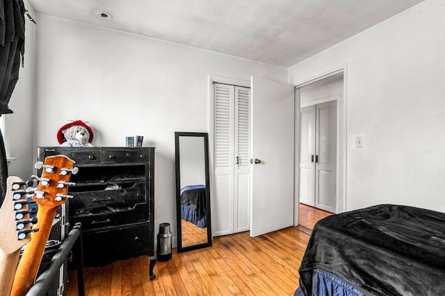 bedroom with a closet and hardwood / wood-style flooring