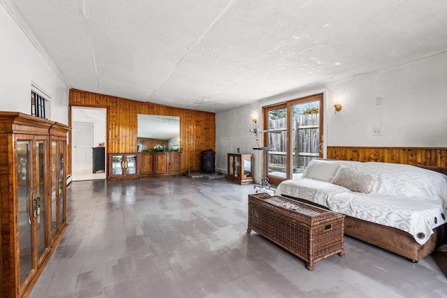 living room with wood finished floors, wood walls, and wainscoting