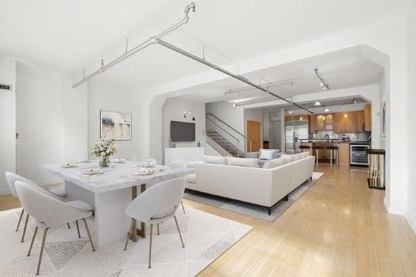 dining room with beverage cooler and light wood-type flooring