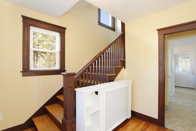 stairway featuring baseboards and wood finished floors