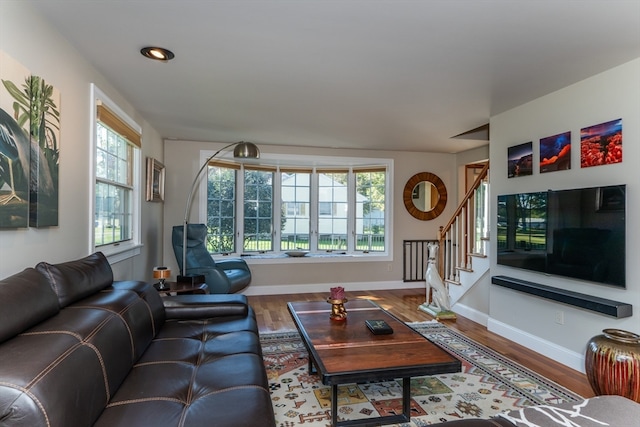 living room featuring a wealth of natural light and hardwood / wood-style flooring