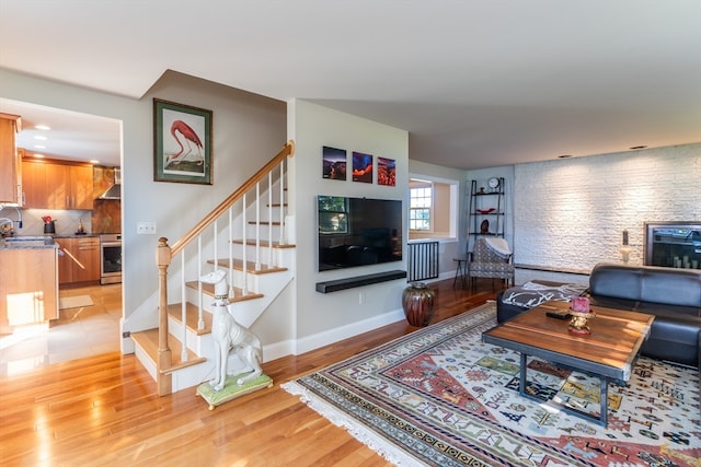 living room featuring light wood-type flooring and sink