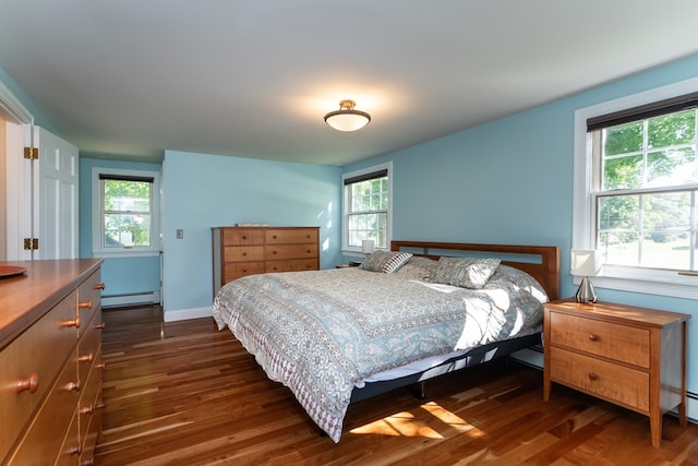 bedroom featuring baseboard heating and dark hardwood / wood-style floors