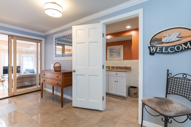 bathroom with ornamental molding and vanity