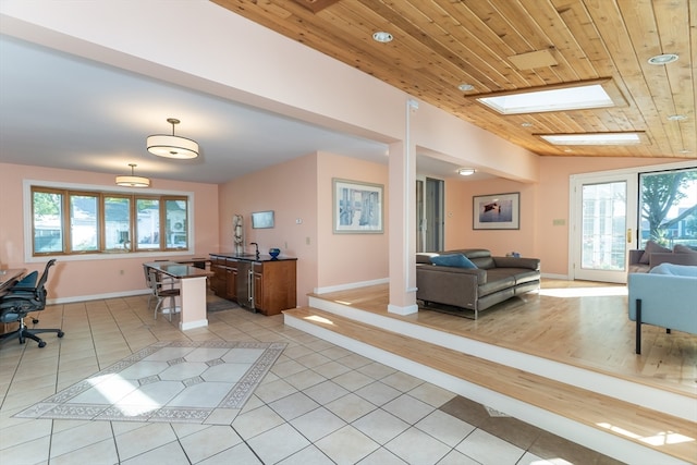 interior space featuring wood ceiling, a wealth of natural light, and lofted ceiling with skylight