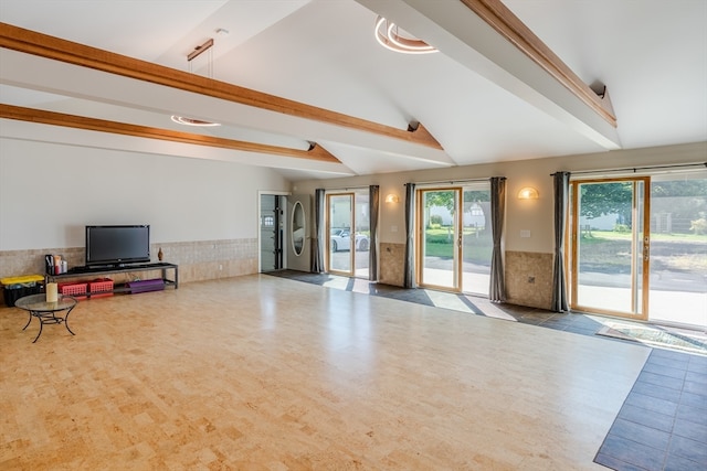 carpeted living room with lofted ceiling with beams