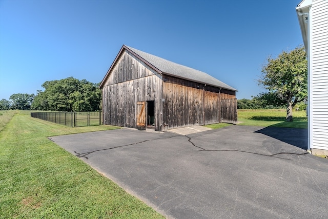 garage featuring a lawn and wooden walls