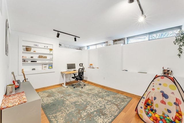 office with track lighting and wood finished floors