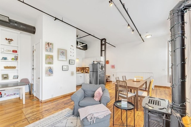 interior space with light wood-style floors and rail lighting