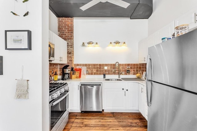 kitchen with a sink, light countertops, exhaust hood, and stainless steel appliances