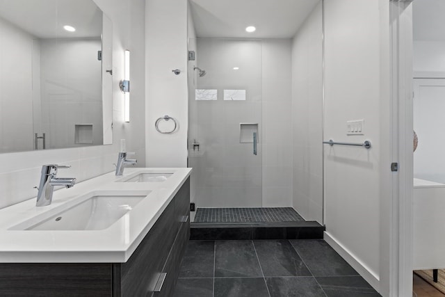 bathroom with backsplash, tile patterned flooring, an enclosed shower, and vanity