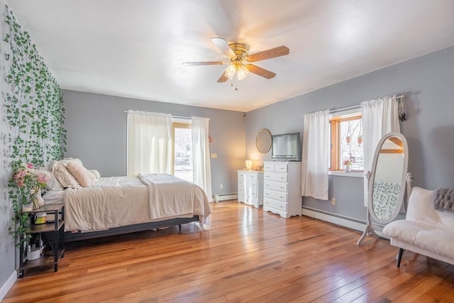 bedroom featuring a baseboard radiator, ceiling fan, and light wood-type flooring