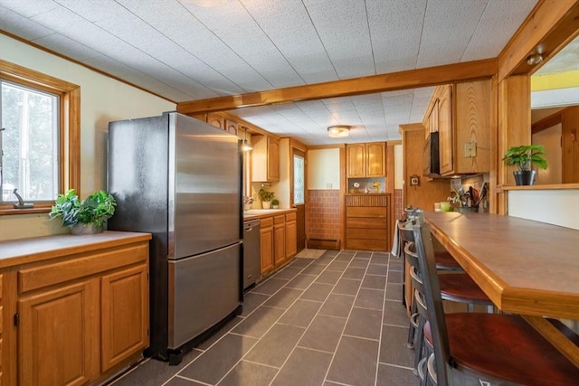 kitchen featuring appliances with stainless steel finishes and dark tile patterned floors