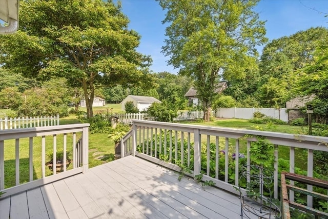 wooden terrace with a lawn