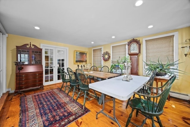 dining space with hardwood / wood-style flooring and french doors