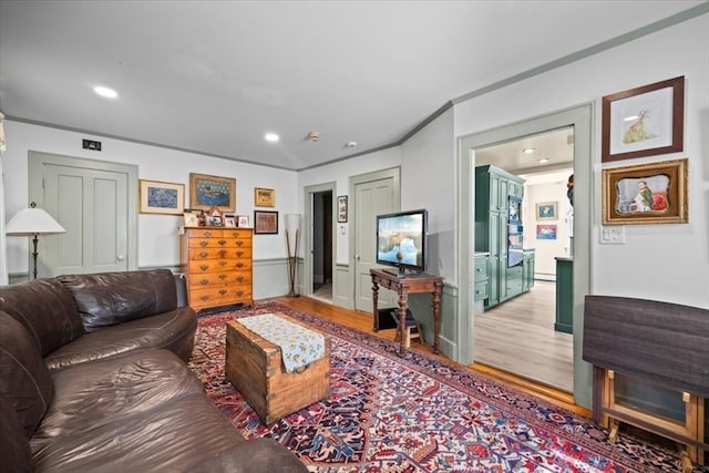 living room featuring hardwood / wood-style flooring and ornamental molding