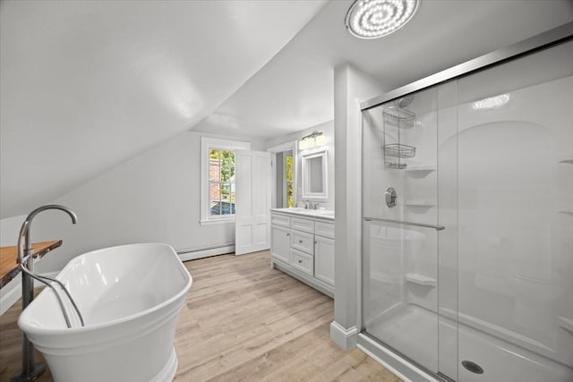 bathroom featuring vanity, shower with separate bathtub, hardwood / wood-style flooring, a baseboard heating unit, and vaulted ceiling